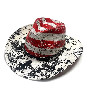 Top view of hand-painted US flag straw cowboy hat with red white stripes and wide brim