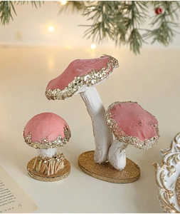 Close-up of pink velvet mushroom ornaments with gold glitter edges and rustic pine decor