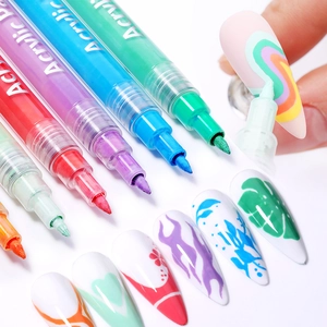 Macro shot of 12-color acrylic nail art pens drawing rainbow patterns on nail tips