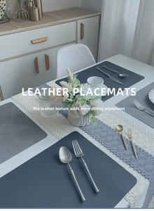Close-up of heat-resistant leather placemat showing faux linen texture and grey finish