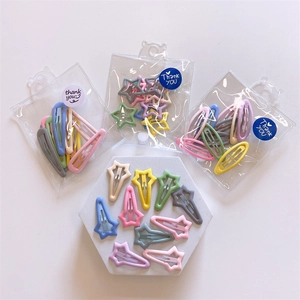 Detailed view of assorted candy-colored star and teardrop hair clips in bear packaging