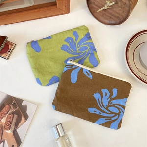 Detailed view of floral canvas storage pouches with white zippers for daily essentials