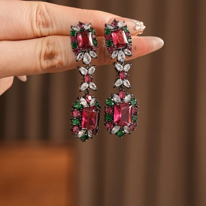 Detail of vintage drop earrings with ruby and emerald colored cubic zirconia stones