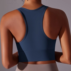 Detail of navy blue racerback sports bra showing cross-back design and seamless fabric