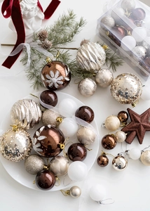Close-up of champagne and brown Christmas baubles with glitter and matte finishes