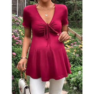 Detail of V-neck maternity top with front drawstring ties and knit texture in rose red