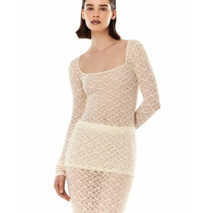 Detailed close-up of beige lace texture and sheer mesh sleeve design of a slim-fit outfit