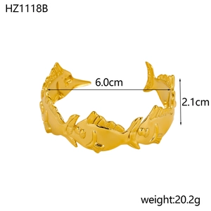Golden fish-shaped cuff bracelet with detailed scales and adjustable open design