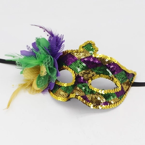 Detail of Mardi Gras mask with purple, green, and gold sequins and vibrant side feathers