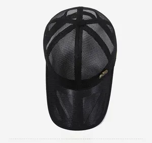 Close-up of black breathable mesh baseball cap with vintage bronze metal badge detail