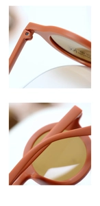 Macro detail of orange matte children sunglasses frame with UV400 protection logo