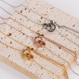 Quilted interlocking double ring pendant necklace in silver, gold, and rose gold finish
