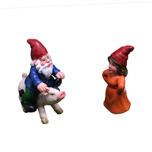 Garden gnome statues set featuring a gnome riding a pig and a female gnome figure