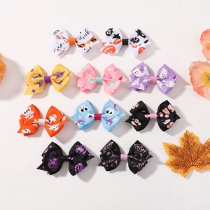 Flat lay of 11 Halloween bow hair clips with ghost and pumpkin patterns on white background