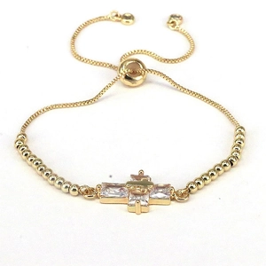 Detail of gold cross bracelet with clear cubic zirconia and adjustable slide closure