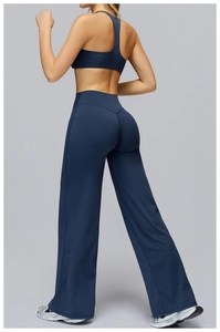 Rear view of high-waisted navy blue yoga set with flare leggings and supportive sports bra