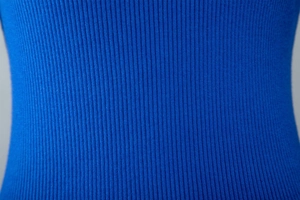 Detailed close-up of high-quality royal blue ribbed knit fabric with soft elastic texture