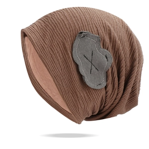 Brown ribbed knit slouchy beanie featuring a grey cloud patch on white background