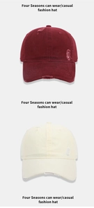 Detailed view of distressed washed cotton baseball caps in burgundy and beige colors