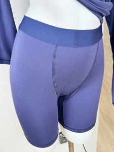 Detailed view of purple knit lounge shorts with wide elastic waistband on mannequin