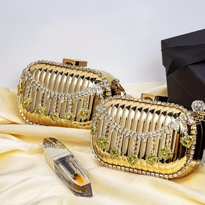 Luxury gold evening bag with wave texture metal finish and rhinestone tassels