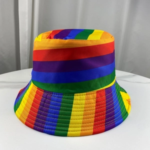 Close-up of rainbow striped bucket hat showing vibrant colorful fabric on marble surface