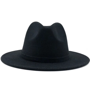 Detailed texture of black wool felt fedora hat featuring a classic wide flat brim style