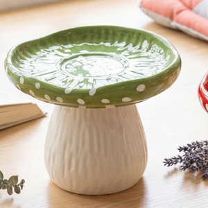 Close-up of green mushroom-shaped tray with white polka dots and textured stem detail
