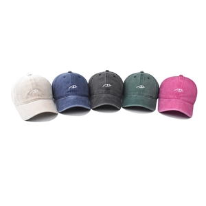 Five assorted colors of washed cotton baseball caps with embroidered cartoon eyes logo