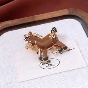 Macro shot of vintage pony brooch with enamel finish and sparkling crystal details