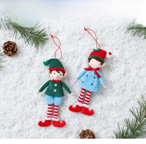 Plush Christmas elf ornaments with sequin hats and striped socks on a snowy background