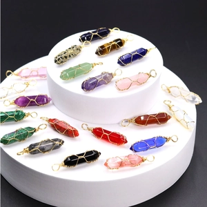 Macro shot of assorted hexagonal crystal pendants with intricate wire-wrap detailing