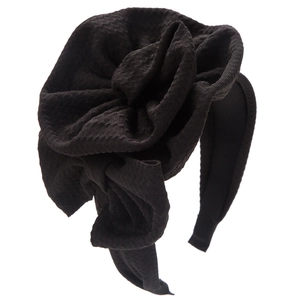 Detailed view of black textured fabric headband with tiered large rose floral design