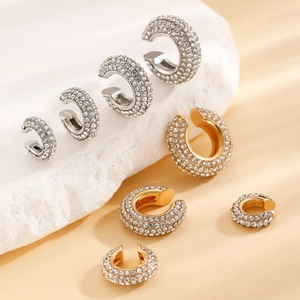 Detailed view of various sizes of C-shaped rhinestone ear cuffs in gold and silver finish