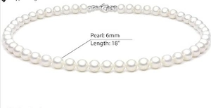 Detail view of 6mm white pearl necklace with 18-inch length and silver lobster clasp