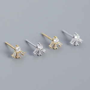 Macro shot of s925 silver crown earrings with baguette zircon in gold and silver finish