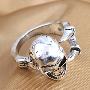 Vintage silver skull wing open ring with punk gothic style on gold silk background