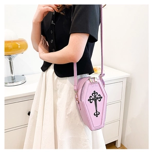 Lilac purple gothic coffin-shaped crossbody bag with black cross on indoor model