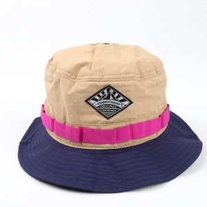 Detail of color-block sun hat featuring quick-dry nylon fabric and mountain patch