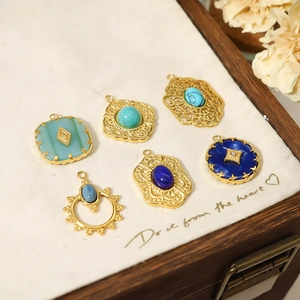 Close-up of vintage bohemian stone pendants in various shapes inside a wooden jewelry box