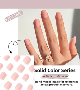 Detailed view of matte coral pink press-on nails with plain solid color design