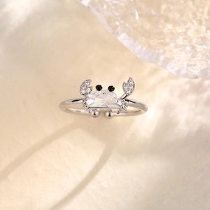 Detail of creative crab ring with moon-shaped zircon and micro-pave claws