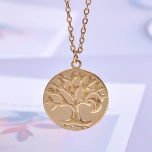Detailed close-up of golden Tree of Life and Moon circular pendant necklace charm