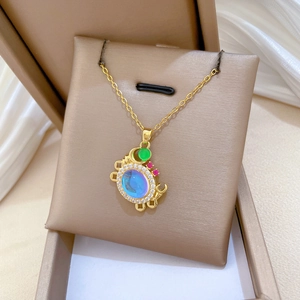 Macro shot of crab pendant necklace with blue iridescent stone and colorful crystals