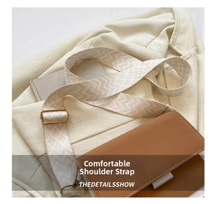 Detail of bicolor leather crossbody bag with wide geometric jacquard strap and gold buckle