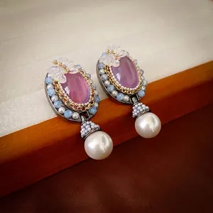 Vintage style oval purple crystal earrings with butterfly accents and large pearl pendants