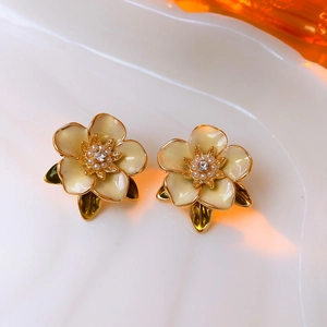 Vintage gold-plated floral earrings with cream enamel petals and pearl accents
