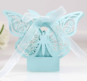 Detailed laser-cut blue butterfly favor box with elegant white ribbon for wedding gifts
