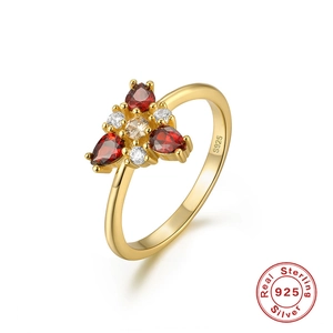 Macro detail of gold plated S925 sterling silver ring with red teardrop gemstones