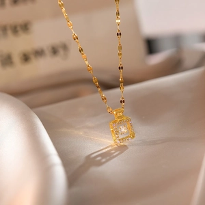 Elegant 18k gold perfume bottle pendant necklace with sparkling diamonds on silk